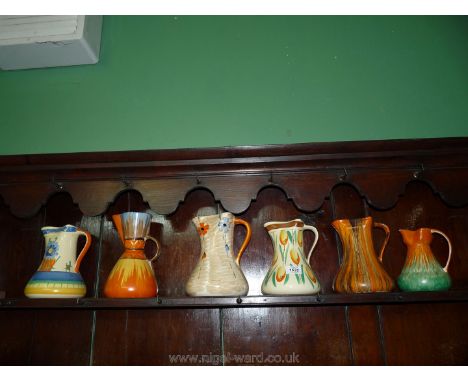Six colourful Myott Jugs, various patterns including a tulip design, etc.