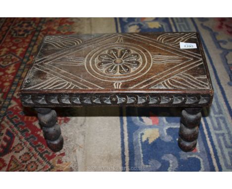A carved low Stool having bobbin turned legs, 15 3/4'' x 9 1/4'' x 8 3/4'' high