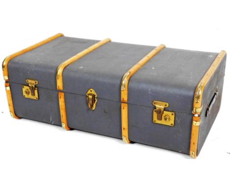 An early 20thC steamer trunk, of oblong form, partially wooden bound, with side handles, pressed blue covering, 32cm H, 93cm 