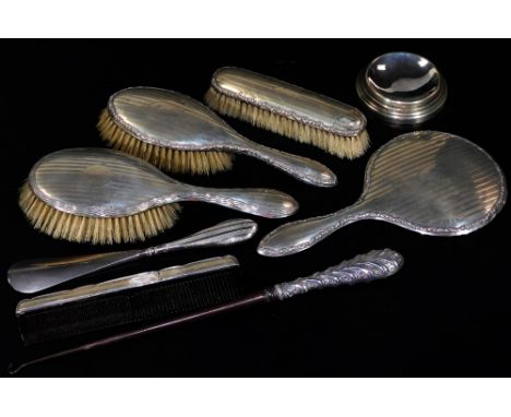 A George V silver four piece dressing table set, comprising two hair brushes, hand mirror, 25cm H, and a clothes brush, each 