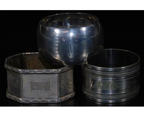 Three various silver napkin rings, to include an octagonal engine turned example, named Diana to the cartouche, 6cm W, etc., 