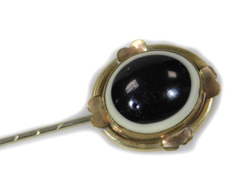 A bulls eye agate stick pin, the single stone set to the pin in a four point gold border, unmarked, 8cm L overall. 