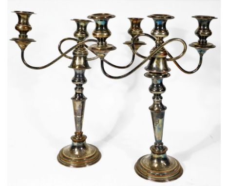 A pair of early 20thC Old Sheffield plate three branch candelabra, each with entwined attachments, tapering stems and stepped