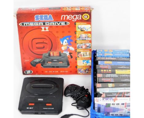 An original Sega Mega Drive II 16 bit computer game console, partially boxed, 35cm W, and a number of games to include The Te