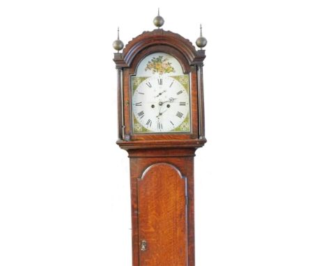 Debenham Sudbury. A 19thC oak long cased clock, the arched dial surmounted by three finials above an arched long trunk door o