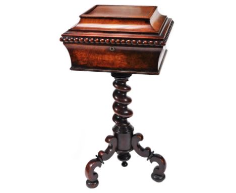 An early Victorian rosewood teapoy, the rectangular sarcophagus top with an elongated beaded border, revealing a fitted inter