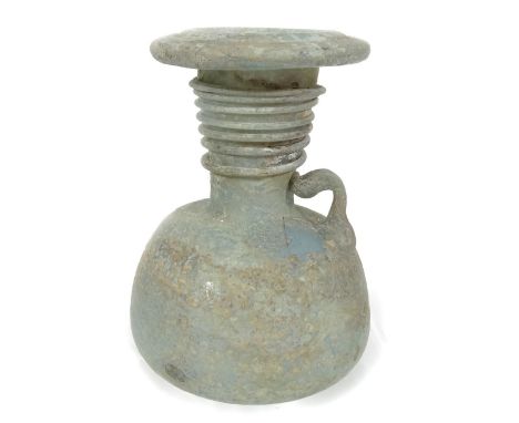 A Roman glass vessel, possibly a lamp, of turned form, on shaped base, 11cm H.