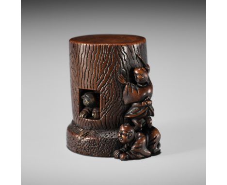 TADASHIGE: A WOOD KARAKURI (TRICK) NETSUKE OF A KARAKO CRAWLING THROUGH THE LUCKY PILLAR AT TODAJIBy Tadashige, signed Tadash