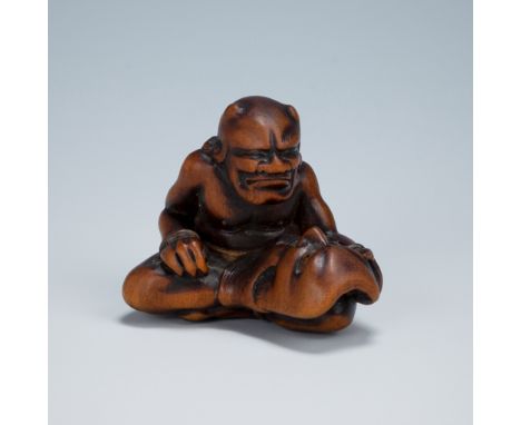GYOKKEI: A WOOD NETSUKE OF AN ONI INSPECTING A SHOKI MASKBy Gyokkei, signed Gyokkei 玉圭Japan, Edo (Tokyo), mid to late 19th ce