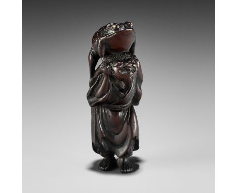 A WOOD NETSUKE OF GAMA SENNIN WITH TOADJapan, c. 1800, Edo period (1615-1868)The charming netsuke finely carved as Gama senni