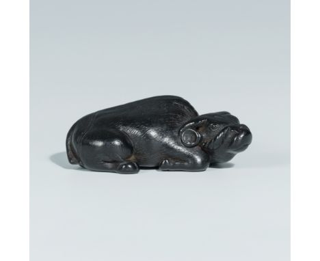 A GOOD EBONY WOOD NETSUKE OF AN OXInscribed Masanao 正直Japan, 19th century, Edo period (1615-1868)Lying with its head lowered 