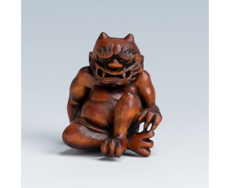 MASAKAZU: A WOOD NETSUKE OF AN ONI SEATED ON A RATBy Masakazu, signed MasakazuJapan, 19th centuryFinely carved in the form of