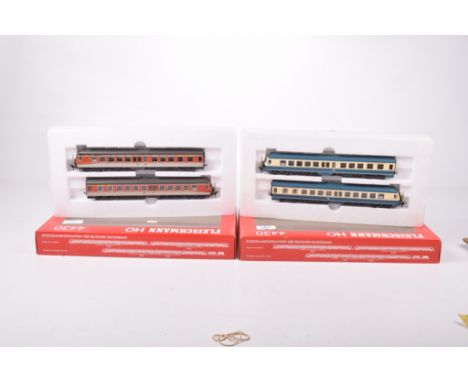 Two boxed Fleischmann HO gauge twin diesel rail car sets4430 in beige and red DB livery and 4430 in blue green/cream DB liver