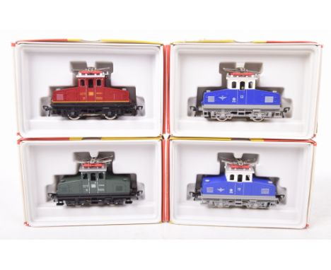 Four boxed Fleischmann HO gauge electric shunter locomotives 4300 in dark green DB livery, 2x 4305 in bright blue, white and 