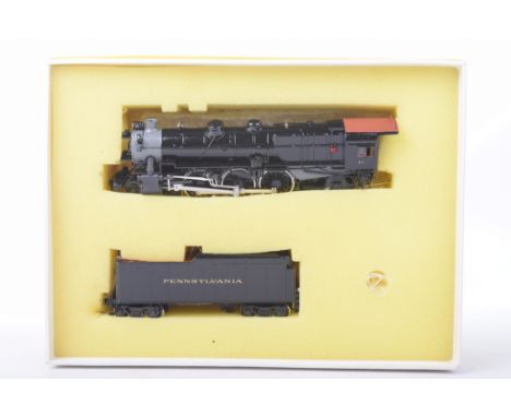 A boxed Sunset Models HO gauge SD Series PRR 4-6-2 K-4 locomotive With eight wheel tender in black livery.