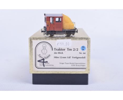 A boxed Ferro-Suisse HOm gauge Tm2/2 diesel tractor locomotive No. 64 in red livery.