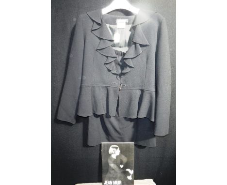 JEAN MUIR: A BLACK SILK FLUTED JACKET AND SKIRT with bugle button detail to jacket, size 10, and a Jean Muir book