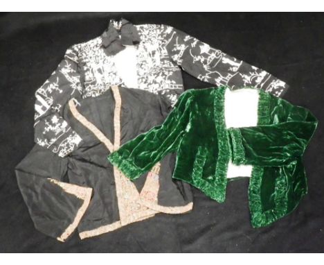 A SHORT BLACK SILK JACKET EMBROIDERED WITH ORIENTAL SCENES, a short green velvet bolero, with ruffled detail to the neck and 