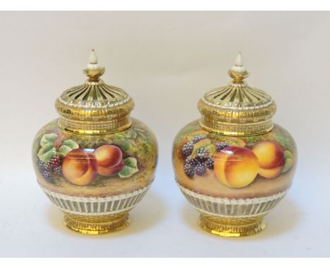 A matched pair of Royal Worcester pot pourri vases and pierced covers, the squat baluster bodies with basket weave, textured 