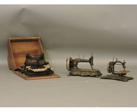 A Royal Barlock typewriter, a Universal sewing machine, and another