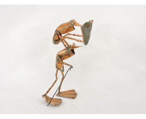 A humorous hand beaten copper sculpture, depicting a frog leapfrogging an elder frog, the elder holding a walking stick, heig