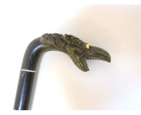 A Chinese sectional horn walking stick, with carved dragon head handle, 82cm long