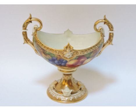 A Royal Worcester navette shaped sweetmeat dish, with scrolling handles to either side, decorated with peaches and grapes, si