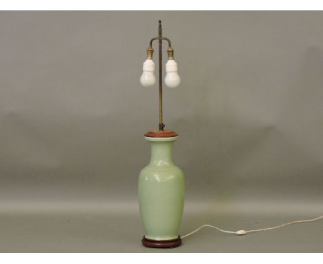 A large celadon glazed table lamp, with silk shade