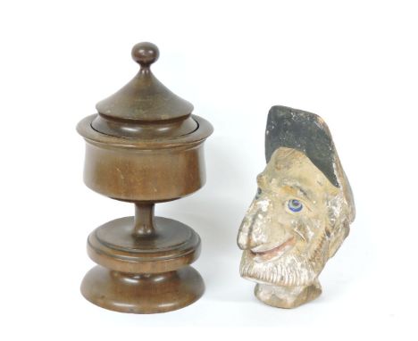 A carved and painted wooden puppet head, as a man with a large nose, 18cm high, and a turned yew wood chalice, 23cm high