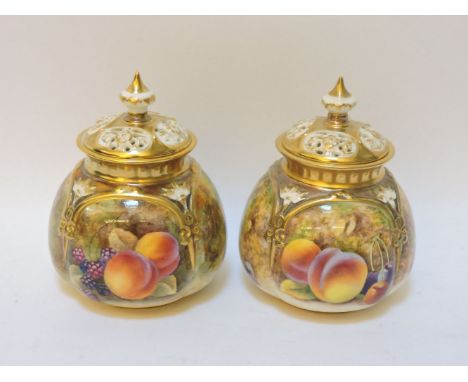 A pair of small Royal Worcester pot pourri vases, each with pierced cover, and each decorated with hand painted fruit, signed