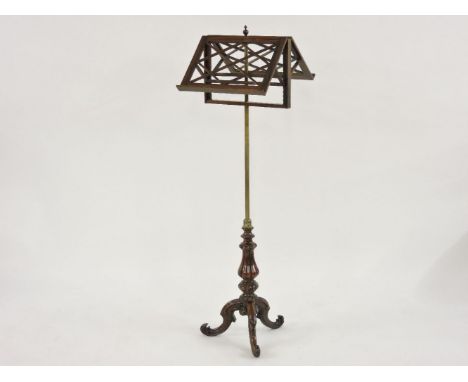 A 19th century rosewood and gilt brass duet music stand, with carved scrolling tripod base, 141cm tall