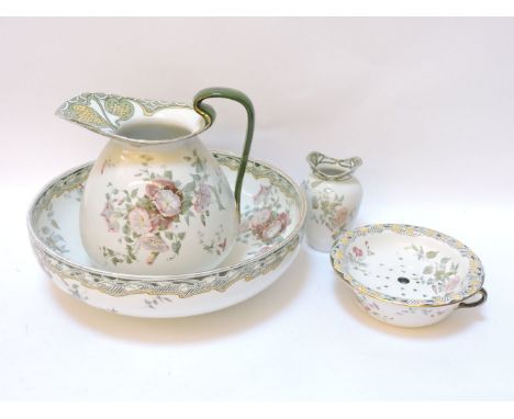A Royal Doulton jug and basin, soap dish, and brush holder