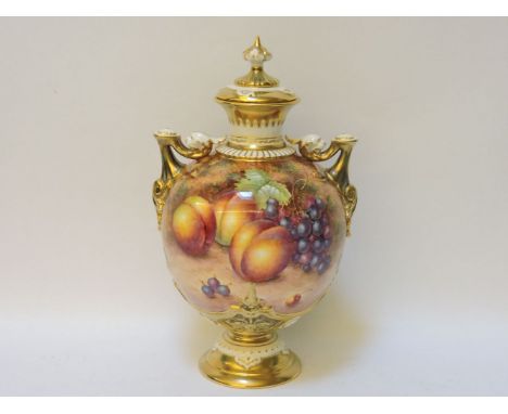 A large Royal Worcester two handled vase and cover, with parcel gilt decoration and hand painted peaches, blackberries and gr