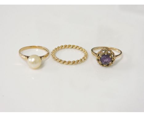 A 9ct gold amethyst ring, a 9ct gold cultured pearl ring, and a 9ct gold twisted wire ring, 1977, 6.8g