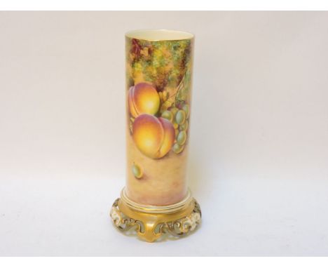 A Royal Worcester porcelain cylindrical spill vase, decorated with hand painted fruit, signed Bowen, on a pierced scrolling f