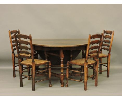 A reproduction George III style oak gateleg table, 130cm wide, 180cm open, and a set of four ladder back chairs