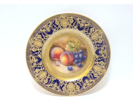 A Royal Worcester porcelain plate, central roundel, painted with fruit signed R Sebright, within cobalt blue and gilt highlig