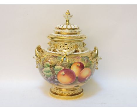 A large Royal Worcester porcelain urn and cover, with looped handles to either side, with applied swags, decorated with hand 