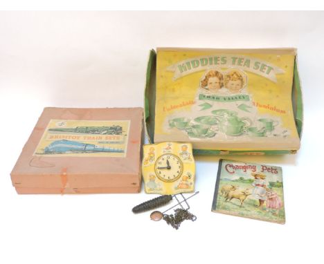 A Chad Valley child's wall clock, weights and pendulum, a boxed Chad Valley teaset, Changing Pets books, Brimton? train set, 