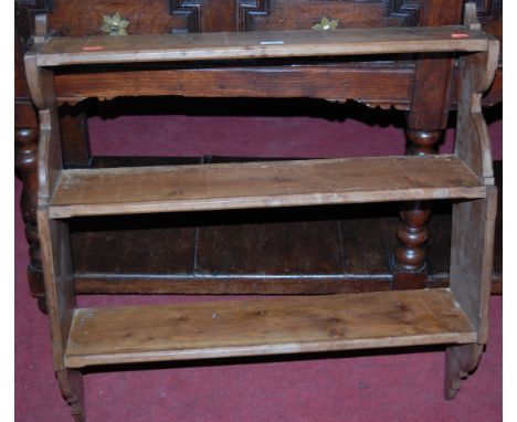 A late Victorian pine three-tier hanging wall shelf 