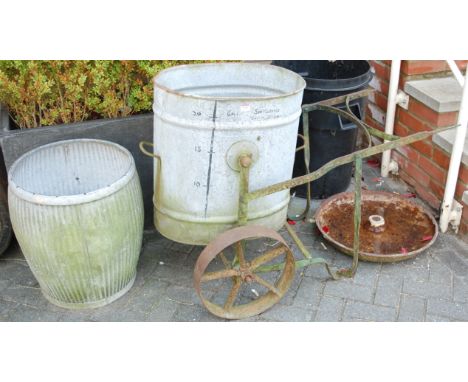 A galvanized metal grain bucket on wrought metal push-along trolley; together with a galvanized metal planter; and a cast iro