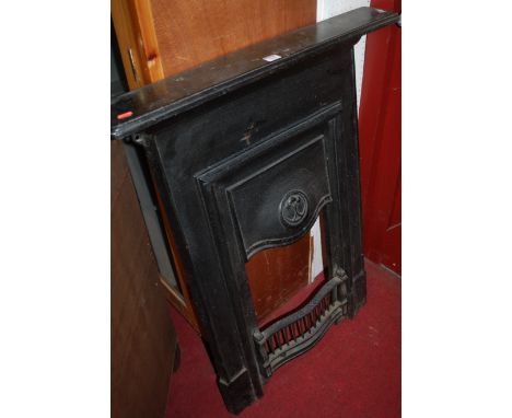 An Edwardian black painted cast iron fire surround