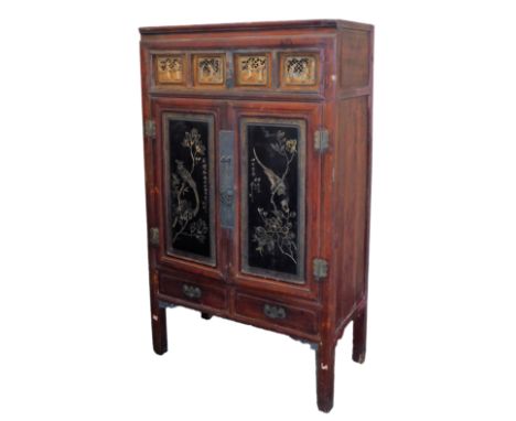 A Chinese red and black lacquer cabinet, with gilt fret work carved panels, over two aesthetic carved doors, 173cm high, 103c