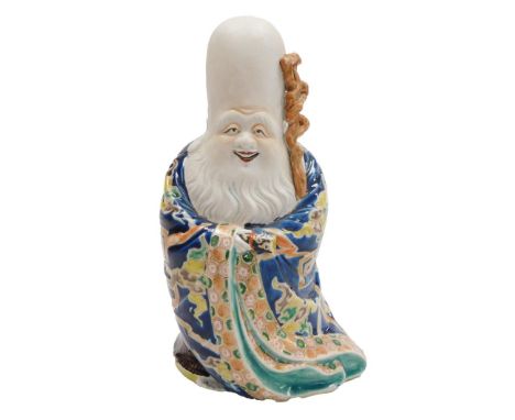A Chinese figure of the Daoist God of Longevity, holding a knotty staff and scroll, with polychrome enamel decoration to his 
