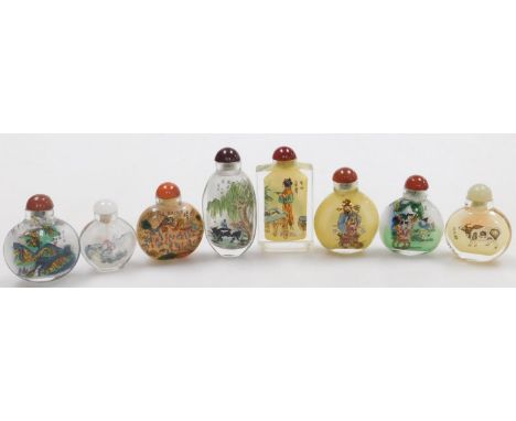 A group of eight Chinese reverse painted snuff bottles, variously decorated to include depictions of children playing, figure