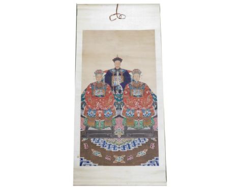 A Chinese ceremonial ancestor portrait scroll, depicting a high ranking court official with two of his wives, all seated in f