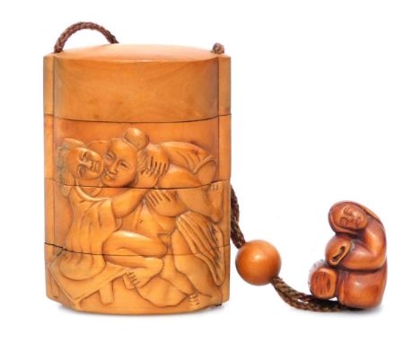 A Japanese carved wood three case inro, carved with male and female figures in erotic positions (shunga), with carved wood ne