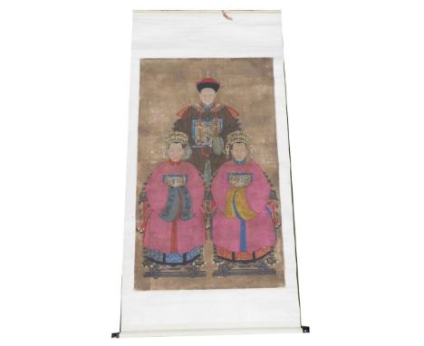 A Chinese ceremonial ancestor portrait scroll, depicting a high ranking court official with two of his wives dressed in pink,