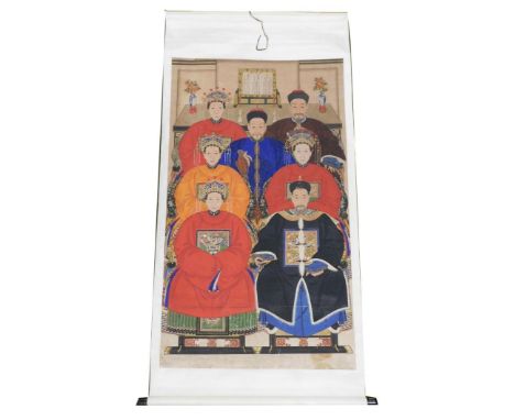 A Chinese ceremonial ancestor portrait scroll, depicting seven family members in front of an altar table bearing a table scre