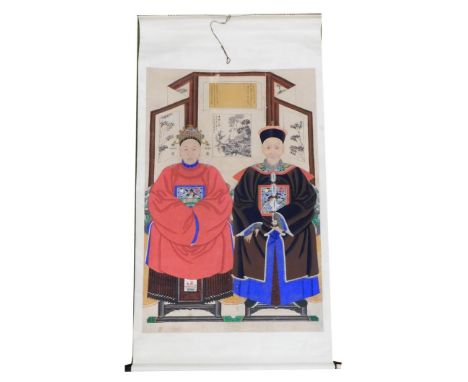 A Chinese ceremonial ancestor portrait scroll, depicting a couple seated in front of a four fold screen, watercolour on silk,